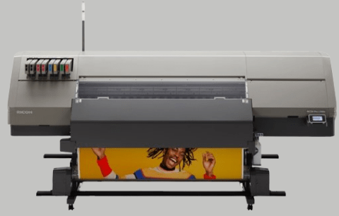 This is a Ricoh Large Wide Format Multifunction Device. It is a large console sized medium gray rectangular shaped device with the following dimensions 129.9"W x 39.3"D x 59"H with dark gray accents and 4.3” LED backlit operation touch panel positioned at the top-right of the machine. Photo is on a medium gray backdrop.